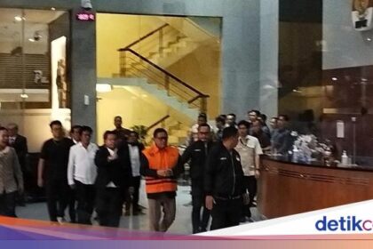 Forexbitcoinstock.com: Potret Hasto Kini Berompi Tahanan Oranye KPK